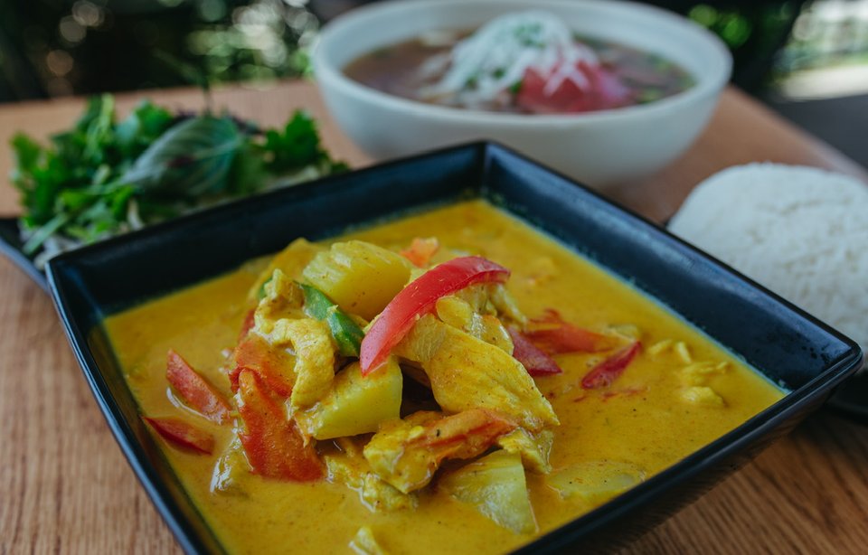 A spread of curry, noodles, and rice.